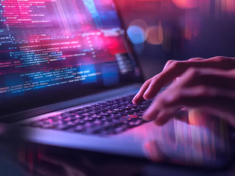 laptop with blue and pink data visualisation for tech due diligence