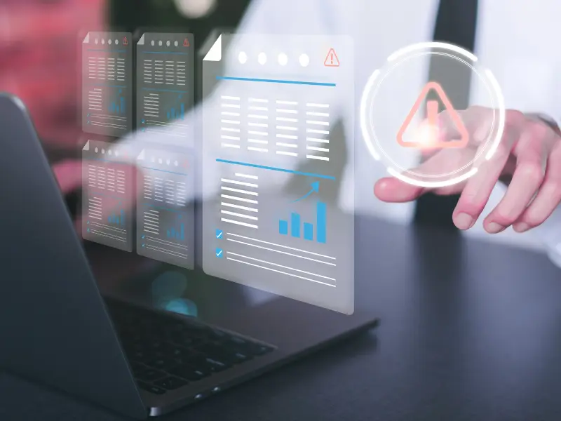 Business professional interacting with digital documents and warning icon, symbolizing risk identification