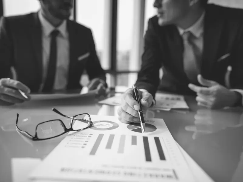 business men looking at a reporting with graphs and charts