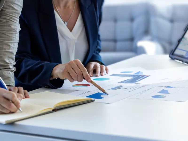 Expertos revisan gráficos e informes de datos durante una evaluación tecnológica para reforzar la confianza de los inversores